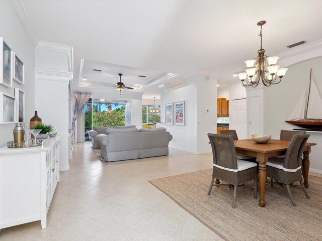1313 Thornapple Dr, Osprey, FL 34229 - dining area featuring ceiling fan with notable chandelier, visible vents, crown molding, a tray ceiling, and baseboards