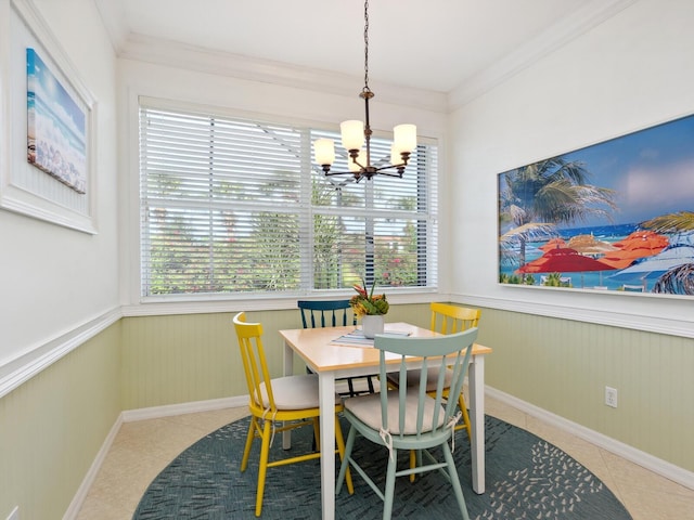 1313 Thornapple Dr, Osprey, FL 34229 - dining room featuring a chandelier, a wainscoted wall, crown molding, tile patterned floors, and baseboards
