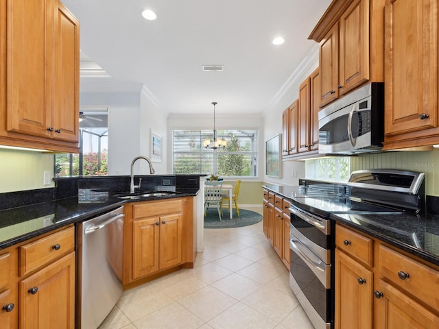 1313 Thornapple Dr, Osprey, FL 34229 - kitchen featuring appliances with stainless steel finishes, a sink, crown molding, brown cabinetry, and light tile patterned floors