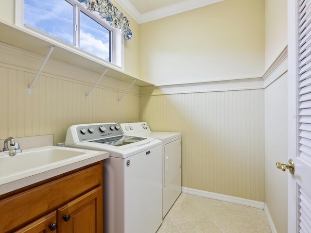 1313 Thornapple Dr, Osprey, FL 34229 - laundry room with washer and clothes dryer, a wainscoted wall, baseboards, light tile patterned flooring, and ornamental molding