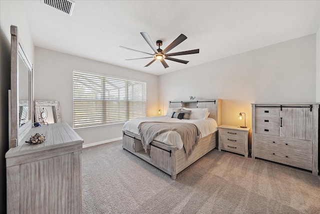 bedroom featuring ceiling fan, light colored carpet, baseboards, and visible vents