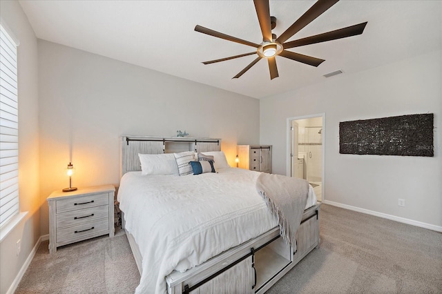 carpeted bedroom featuring visible vents, a ceiling fan, baseboards, and ensuite bathroom