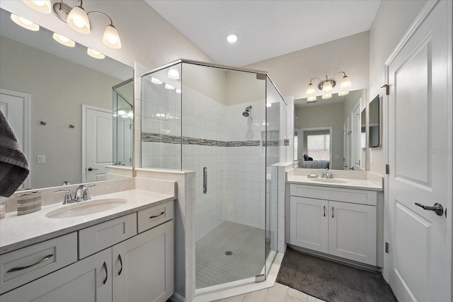 bathroom featuring a sink, connected bathroom, two vanities, and a shower stall