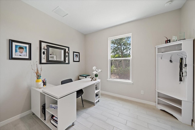 home office with baseboards and visible vents
