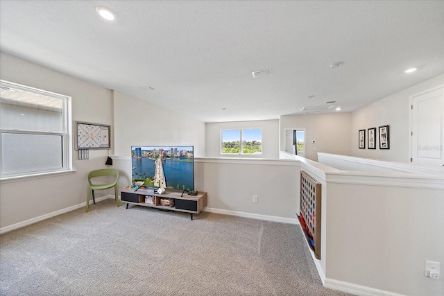 living area featuring baseboards, carpet, and recessed lighting