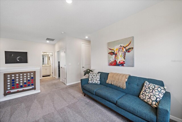 living room with carpet flooring, recessed lighting, baseboards, and visible vents