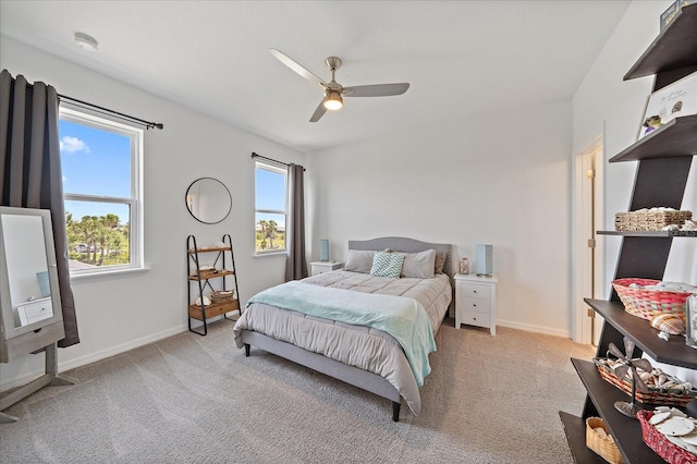 bedroom featuring baseboards, light carpet, and ceiling fan