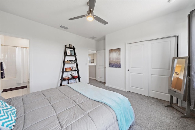 bedroom with ceiling fan, visible vents, carpet floors, a closet, and ensuite bathroom