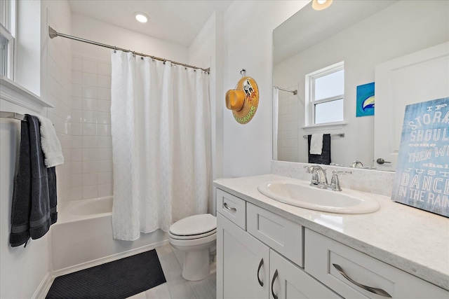 bathroom featuring recessed lighting, vanity, shower / bath combo, and toilet