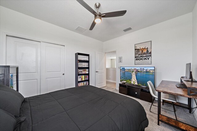 bedroom with visible vents, carpet flooring, a ceiling fan, and a closet