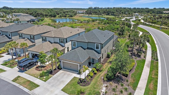 drone / aerial view with a residential view and a water view