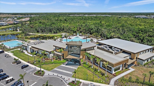 drone / aerial view with a water view and a view of trees