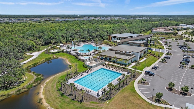 birds eye view of property featuring a view of trees and a water view
