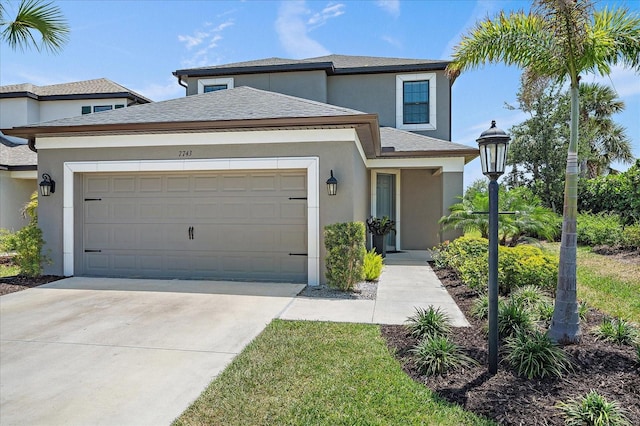 traditional-style home featuring concrete driveway, a garage, roof with shingles, and stucco siding