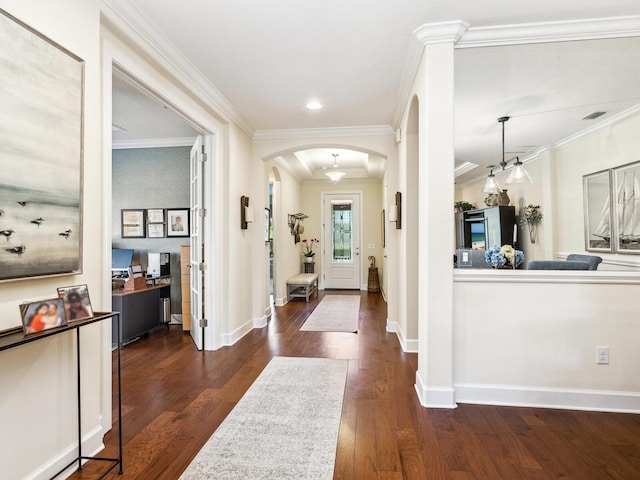 2525 Vaccaro Dr, Sarasota, FL 34231 - entrance foyer with visible vents, arched walkways, wood finished floors, baseboards, and ornamental molding