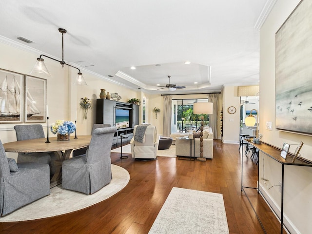 2525 Vaccaro Dr, Sarasota, FL 34231 - dining room with crown molding, ceiling fan, and hardwood / wood-style floors