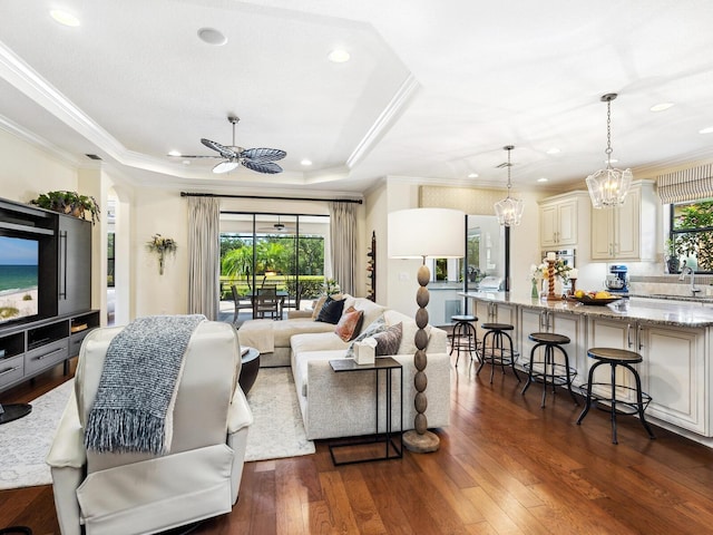 2525 Vaccaro Dr, Sarasota, FL 34231 - living area with recessed lighting, ornamental molding, and ceiling fan with notable chandelier