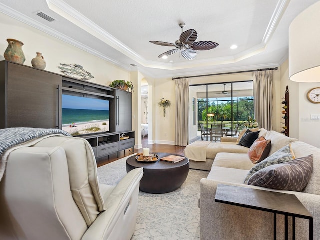 2525 Vaccaro Dr, Sarasota, FL 34231 - living area with visible vents, ornamental molding, wood finished floors, a raised ceiling, and a ceiling fan
