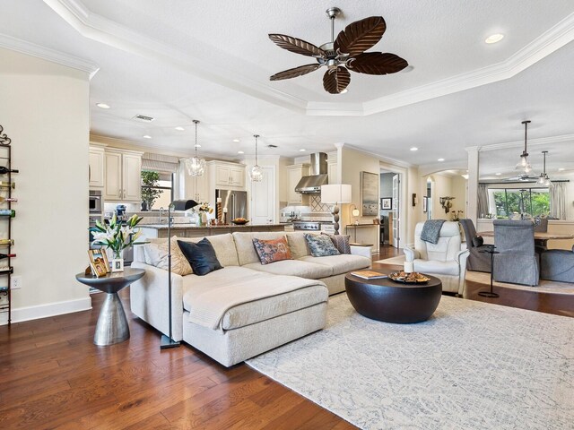 2525 Vaccaro Dr, Sarasota, FL 34231 - living room featuring plenty of natural light, a ceiling fan, a raised ceiling, and decorative columns