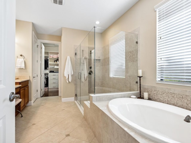 2525 Vaccaro Dr, Sarasota, FL 34231 - full bath with a garden tub, a shower stall, vanity, tile patterned floors, and a spacious closet
