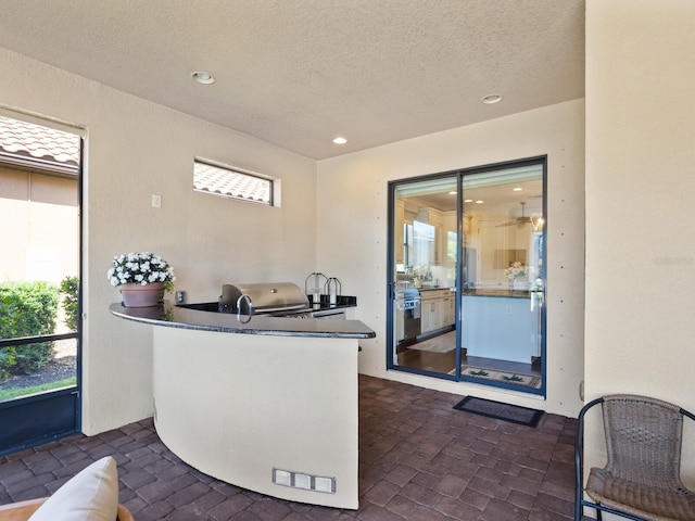 2525 Vaccaro Dr, Sarasota, FL 34231 - bar with recessed lighting, a textured ceiling, and a healthy amount of sunlight