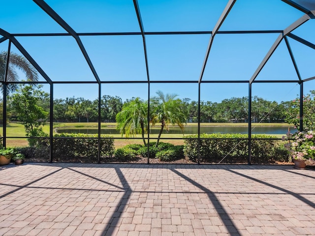 2525 Vaccaro Dr, Sarasota, FL 34231 - view of patio with glass enclosure and a water view