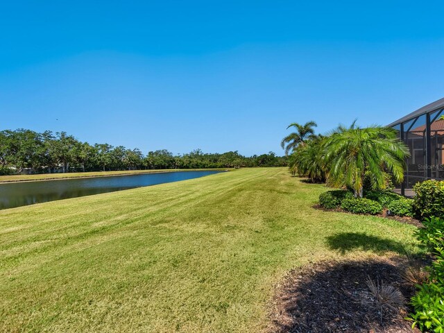 2525 Vaccaro Dr, Sarasota, FL 34231 - view of yard featuring glass enclosure and a water view