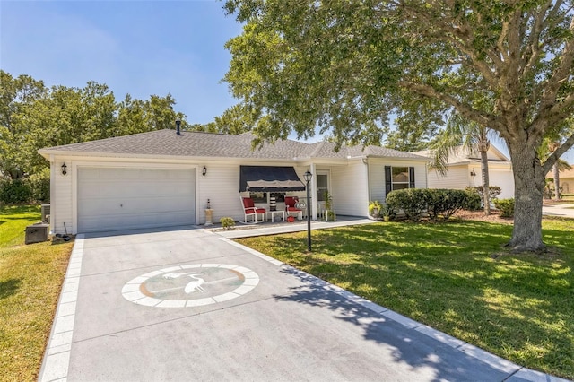 single story home featuring an attached garage, a front yard, and concrete driveway