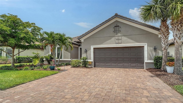 8713 Mangilli Rd, Sarasota, FL 34238 - view of front of property with decorative driveway, stucco siding, a garage, and a front yard
