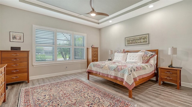 8713 Mangilli Rd, Sarasota, FL 34238 - bedroom with light wood-style flooring, baseboards, a raised ceiling, ornamental molding, and recessed lighting