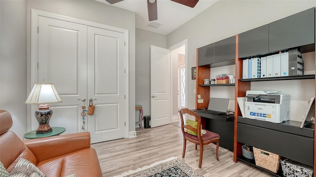 8713 Mangilli Rd, Sarasota, FL 34238 - home office with light wood-style floors, a ceiling fan, and baseboards
