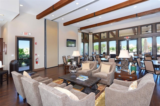 8713 Mangilli Rd, Sarasota, FL 34238 - living room with beamed ceiling, healthy amount of natural light, recessed lighting, wood finished floors, and a towering ceiling