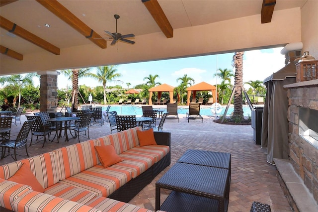 8713 Mangilli Rd, Sarasota, FL 34238 - view of patio featuring a gazebo, an outdoor hangout area, a community pool, a ceiling fan, and outdoor dining area