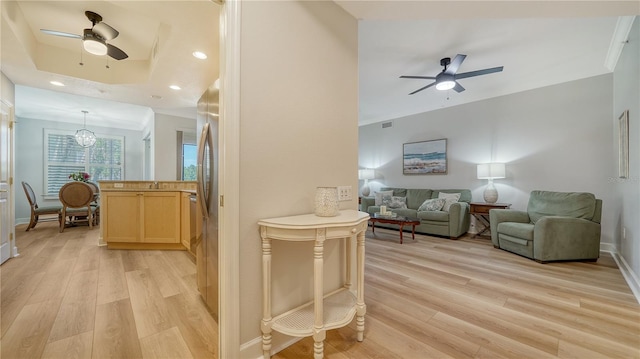 living area featuring recessed lighting, a ceiling fan, and light wood finished floors