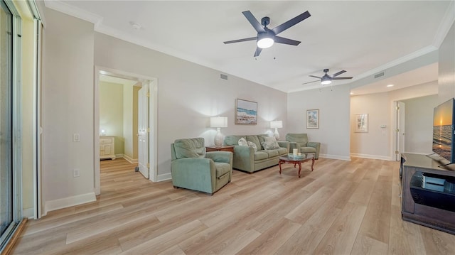 living area with crown molding, a ceiling fan, and light wood finished floors