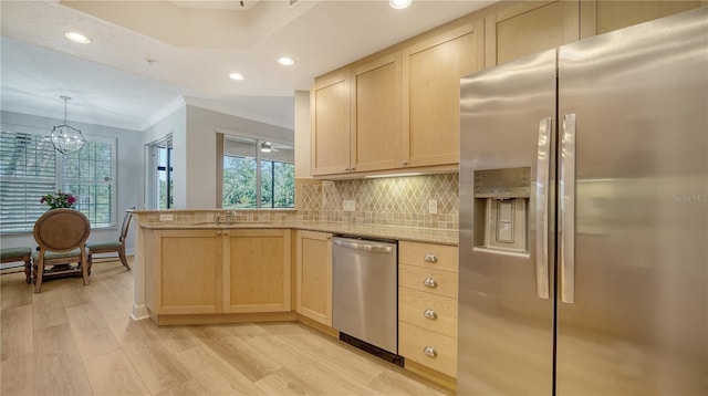 kitchen with stainless steel appliances, light wood-type flooring, a wealth of natural light, and light brown cabinets
