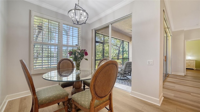 dining area featuring light wood-style floors, baseboards, a wealth of natural light, and a notable chandelier