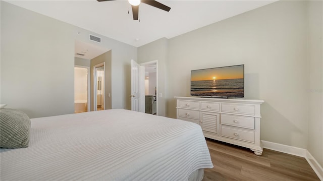 bedroom featuring baseboards, a ceiling fan, wood finished floors, and visible vents
