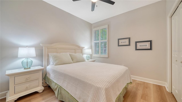 bedroom featuring a closet, baseboards, ceiling fan, and light wood-type flooring