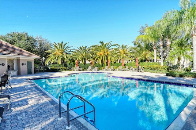community pool featuring a patio and fence