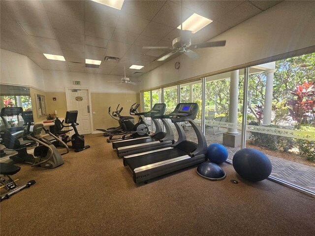 exercise room featuring a healthy amount of sunlight, visible vents, and a paneled ceiling