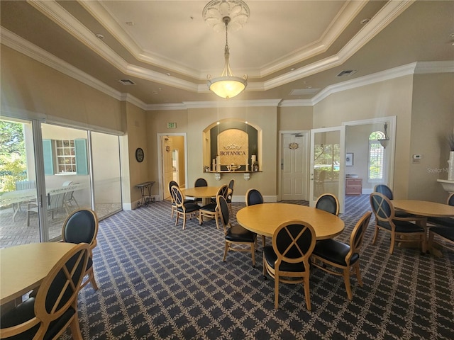 dining room featuring carpet floors, crown molding, visible vents, baseboards, and a tray ceiling