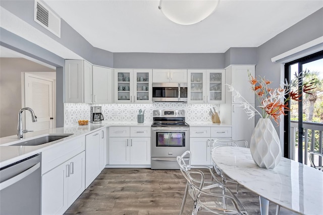 kitchen featuring appliances with stainless steel finishes, visible vents, a healthy amount of sunlight, and a sink
