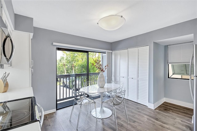 dining space featuring baseboards and wood finished floors
