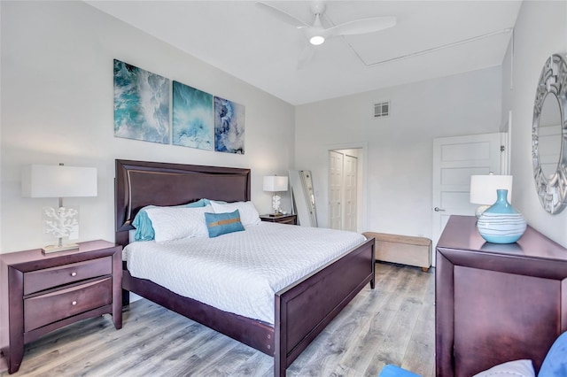 bedroom featuring ceiling fan, a closet, light wood-style flooring, and visible vents