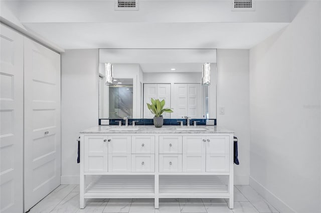bathroom with visible vents, baseboards, and a sink