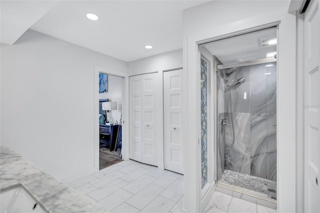 full bath featuring a marble finish shower, a closet, marble finish floor, and recessed lighting