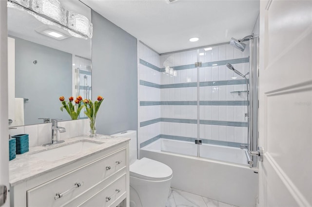 full bath featuring toilet, enclosed tub / shower combo, marble finish floor, and vanity