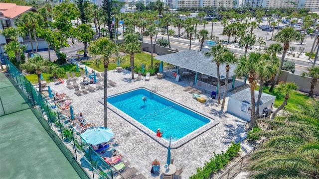 pool with a patio and fence