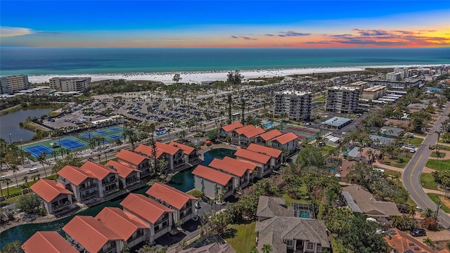 drone / aerial view with a water view and a beach view